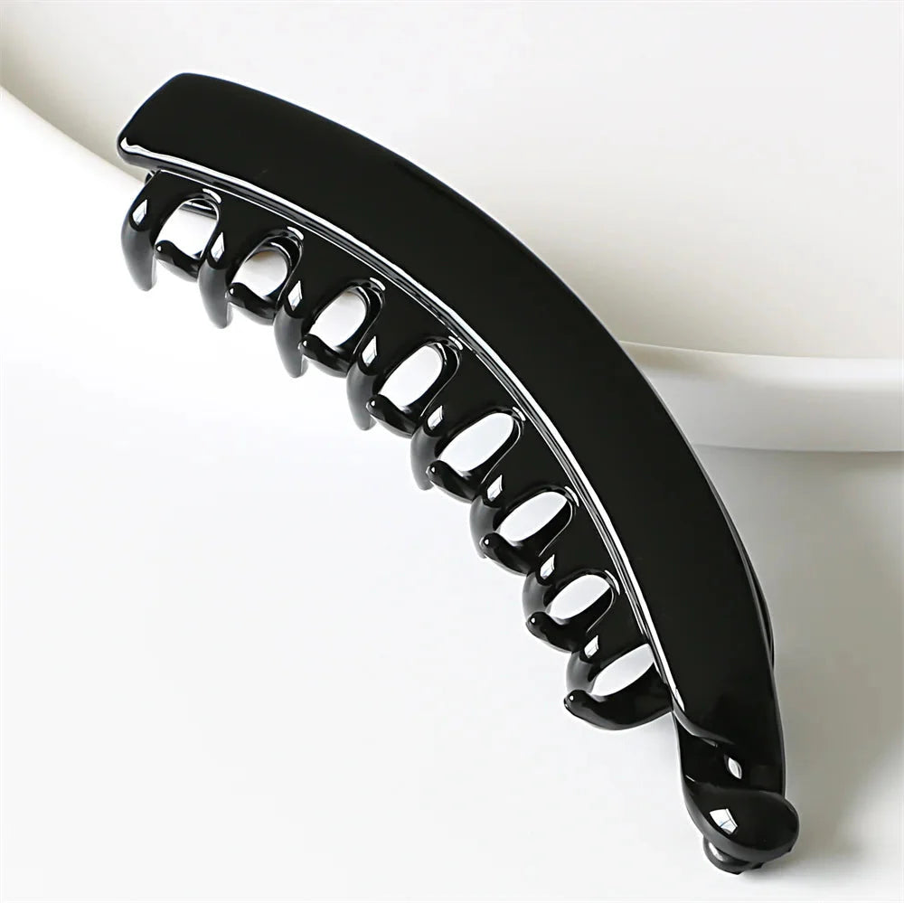 Frosted solid color banana hair clips by Clarivae, stylish ponytail barrettes and hair claws for women, shown in image.