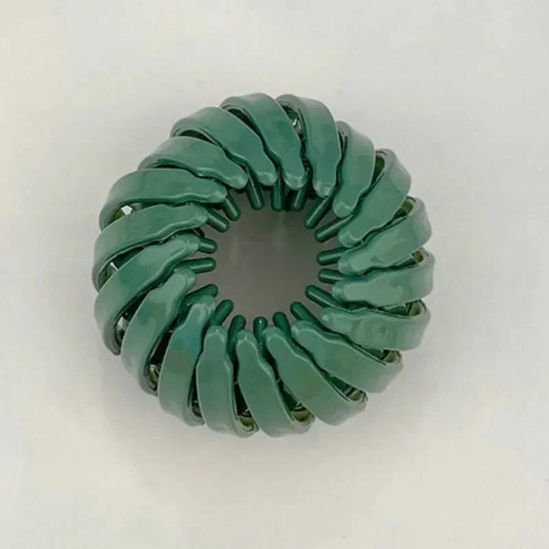 Clarivae bird nest shaped ponytail hair clip, a stylish lazy braider hairpin for effortless hairstyles, shown on a model's hair.