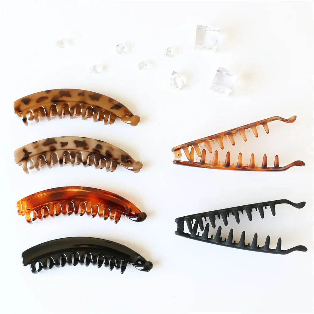 Frosted solid color banana hair clips by Clarivae, stylish ponytail barrettes and hair claws for women, shown in the image.