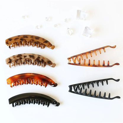 Frosted solid color banana hair clips by Clarivae, stylish ponytail barrettes and hair claws for women, shown in the image.