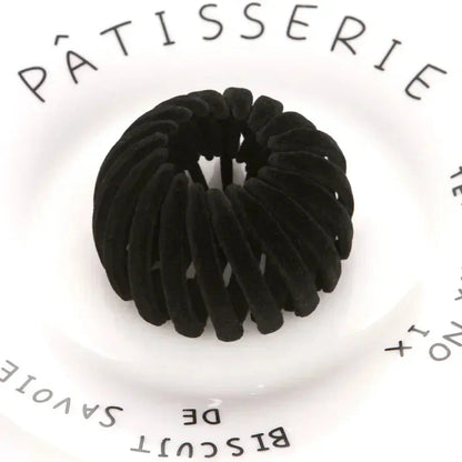 Clarivae bird nest shaped ponytail hair clip with a lazy braid design for effortless hairstyles, shown in a close-up image.